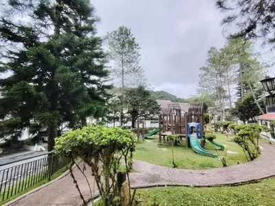a playground in a park with a slide at The Family Hideaway 2 Bedroom Apartment at Equatorial Hill Resort in Brinchang