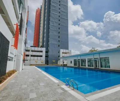 a large swimming pool next to a tall building at The Anderson Condo with NETFLIX with Free Parking with Swimming Pool and at Ipoh City Centre Nearby to all amenities and attractions in Ipoh