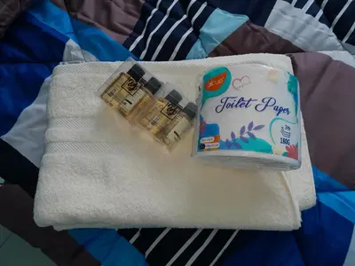 a towel with a packet of toothpaste on it at The Anderson Condo with NETFLIX with Free Parking with Swimming Pool and at Ipoh City Centre Nearby to all amenities and attractions in Ipoh