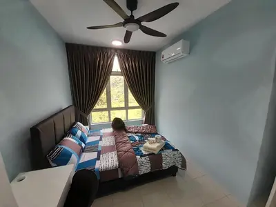 a child sitting on a bed in a room with a window at The Anderson Condo with NETFLIX with Free Parking with Swimming Pool and at Ipoh City Centre Nearby to all amenities and attractions in Ipoh