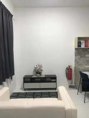 a living room with a white couch and a table at DyMaz Salam Homestay in Seri Iskandar