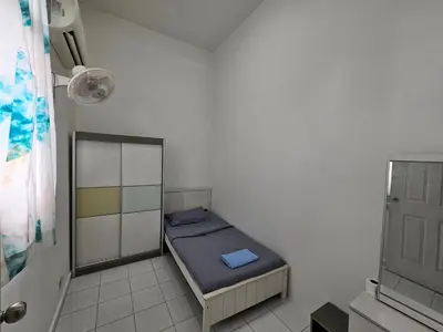 a small bedroom with a small bed in a room at Sunny Point Hostel in Gelugor