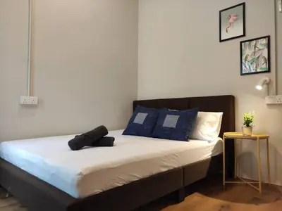 a bed with blue and white pillows on it at Heritage House 4BR with Dipping Pool, Central Location Near Street Art 45 in George Town