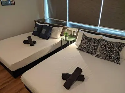 a bedroom with two beds with crosses on them at Heritage House 4BR with Dipping Pool, Central Location Near Street Art 45 in George Town