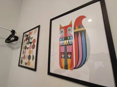 two framed artworks are hanging on a wall at Heritage House 4BR with Dipping Pool, Central Location Near Street Art 45 in George Town