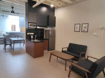 a living room with a couch and a table and a kitchen at Heritage House 4BR with Dipping Pool, Central Location Near Street Art 45 in George Town