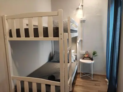 a bedroom with a bunk bed with a ladder at Heritage House 5BR with Dipping Pool, Central Location Near Street Art 47 in George Town