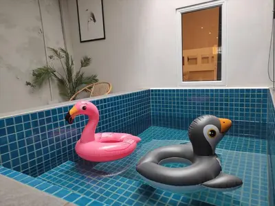 two rubber swans sitting in a tub in a bathroom at Heritage House 5BR with Dipping Pool, Central Location Near Street Art 47 in George Town