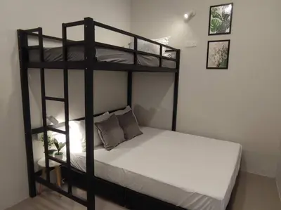 a bedroom with two bunk beds and a white bed at Heritage House 5BR with Dipping Pool, Central Location Near Street Art 47 in George Town