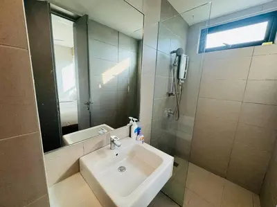 a bathroom with a sink and a mirror at JazzSuite Muji Seafront unit NearStraitsQuay in Tanjong Tokong