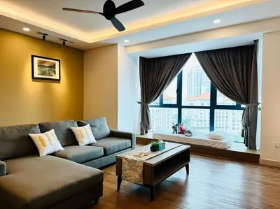 a living room with a couch and a large window at JazzSuite Muji Seafront unit NearStraitsQuay in Tanjong Tokong