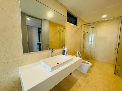 a bathroom with a sink and a toilet and a mirror at JazzSuite Muji Seafront unit NearStraitsQuay in Tanjong Tokong