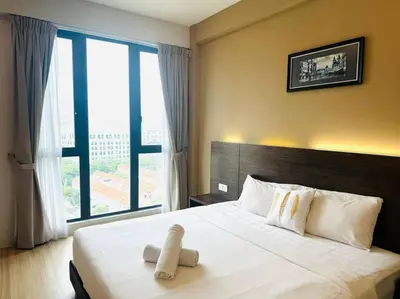 a bedroom with a large bed with a large window at JazzSuite Muji Seafront unit NearStraitsQuay in Tanjong Tokong
