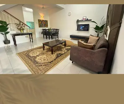 a living room with a couch and a table at Santai Impian Meru Ipoh in Ipoh