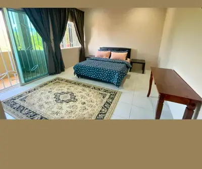 a living room with a couch and a table at Santai Impian Meru Ipoh in Ipoh