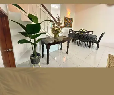 a living room with a table and a potted plant at Santai Impian Meru Ipoh in Ipoh