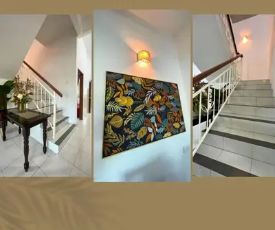 a hallway with a painting on the wall and a staircase at Santai Impian Meru Ipoh in Ipoh