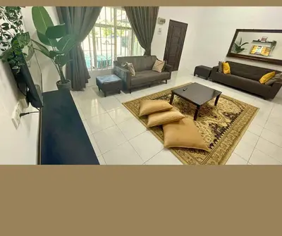 a living room with a couch and a table at Santai Impian Meru Ipoh in Ipoh