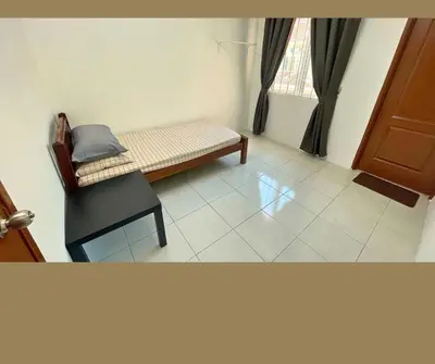 a room with a bench and a chair and a window at Santai Impian Meru Ipoh in Ipoh