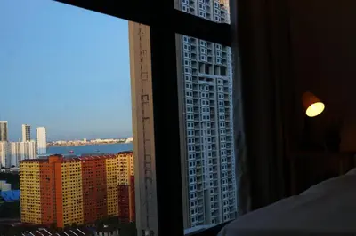 a view of a city skyline from a hotel window at Urban Suites Infinity Pool 3BR 2Carparks 8pax in Jelutong