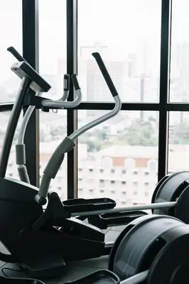a gym with cardio equipment in front of a window at Urban Suites Infinity Pool 3BR 2Carparks 8pax in Jelutong