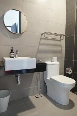 a bathroom with a sink and a toilet and a mirror at Urban Suites Seaview 3Bedrooms 2Carparks 8pax in Jelutong