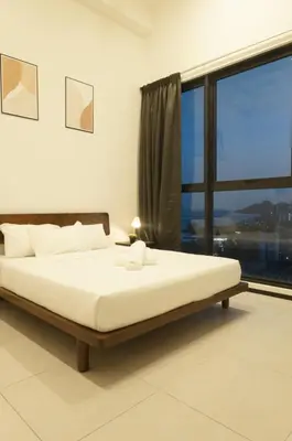 a bedroom with a large bed and a large window at Urban Suites Seaview 3Bedrooms 2Carparks 8pax in Jelutong