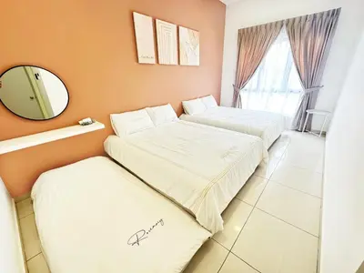 two beds in a room with a mirror at Decozy 9 Ipoh Town Condo 12pax in Ipoh