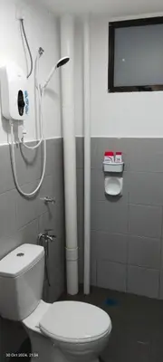 a bathroom with a toilet and a shower at Nana Homestay in Parit Buntar