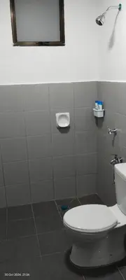 a bathroom with a toilet and a mirror at Nana Homestay in Parit Buntar
