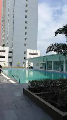 a building with a swimming pool in front of a building at Ipoh Anderson Cozy downtown in Ipoh