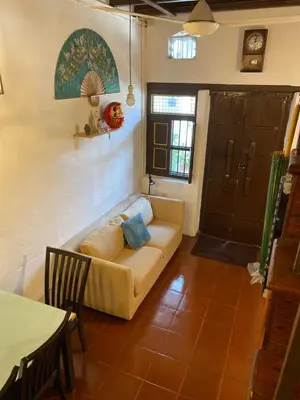 a living room with a couch and a table at EastOriental House in George Town