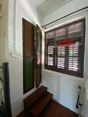 a room with a door and a window and stairs at EastOriental House in George Town