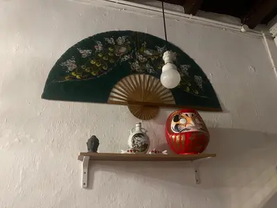a shelf with an umbrella and a vase on it at EastOriental House in George Town