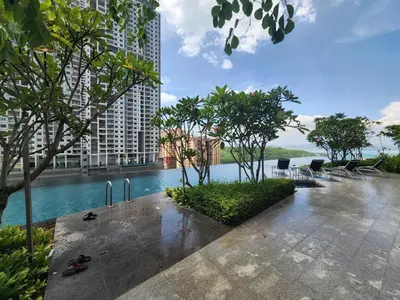 a swimming pool in the middle of a building at Urban Suites - Queens Suite in Jelutong
