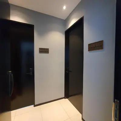 two elevators in a building with signs on the wall at Urban Suites - Queens Suite in Jelutong