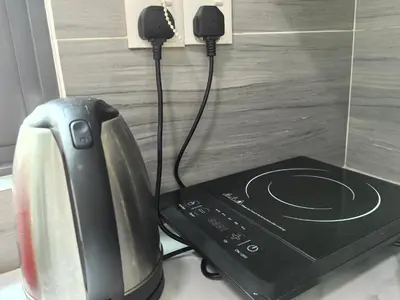 a computer monitor and a router on a counter at Platinum Suite Meritus by Moowin in Perai