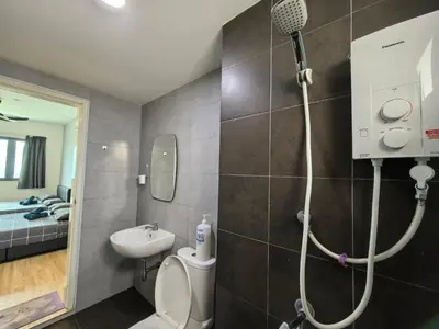 a bathroom with a shower and a toilet and a sink at Platinum Suite Meritus by Moowin in Perai