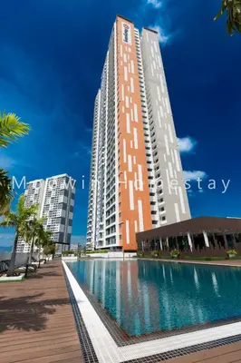 a large building with a swimming pool in front of it at Platinum Suite Meritus by Moowin in Perai