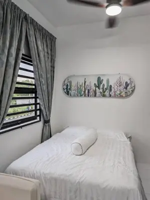 a white bed in a room with a window at Comfortable Greenery in Seri Iskandar