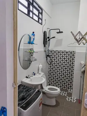 a small bathroom with a toilet and a sink at Comfortable Greenery in Seri Iskandar