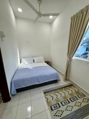 a bedroom with a bed and a ceiling fan at Rimbayu 81 in Kampung Bota Kiri