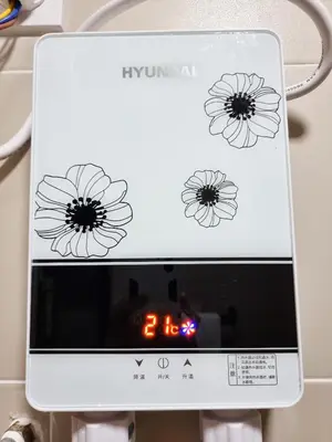 a digital clock with three flowers on it at Mossy Forest Family Retreat III, 2-8pax, Sunrise View, Cameron Highlands in Cameron Highlands