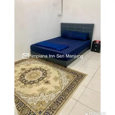 a room with a bed and a rug on a floor at Impiana Inn Seri Manjung in Seri Manjung