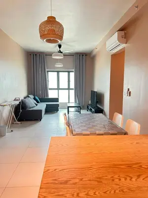 a living room with a large wooden table in a room at Apartment in Batu Kawan in Batu Kawan