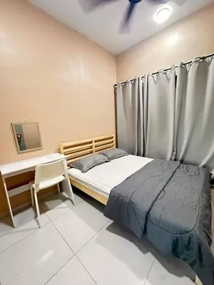a bedroom with a bed and a window with a curtain at Apartment in Batu Kawan in Batu Kawan