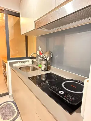a kitchen with a stove and a sink at Apartment in Batu Kawan in Batu Kawan