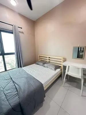 a bedroom with a bed and a table and a window at Apartment in Batu Kawan in Batu Kawan