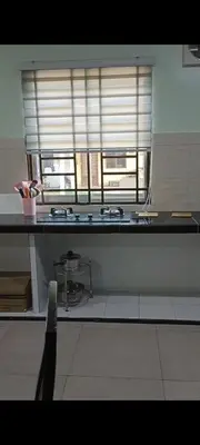 a kitchen with a sink and a window at NHR Harmoni in Simpang Ampat