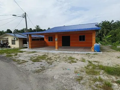 a small orange house with a blue roof at NHR Harmoni in Simpang Ampat
